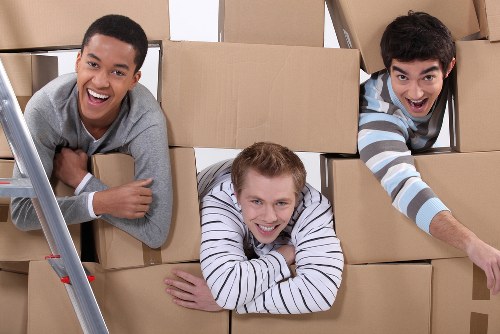 Professional packers organising household boxes in a Kew home