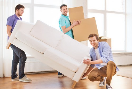 Removal van outside a Kew flat with movers carrying items